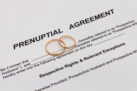 Prenuptial agreement document with two wedding rings