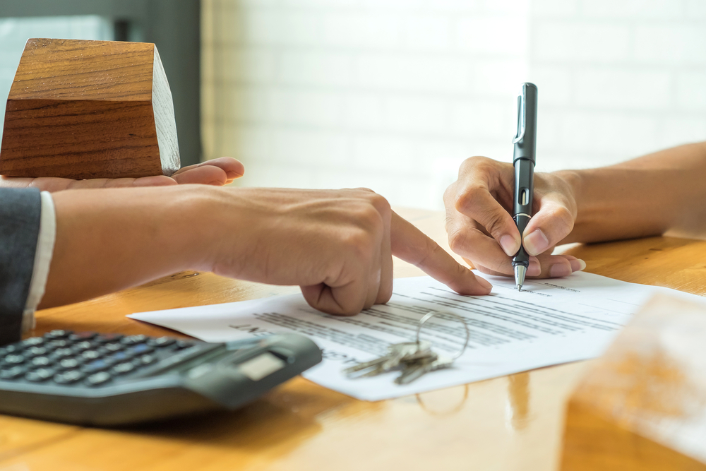 business owner signing lease agreement on table