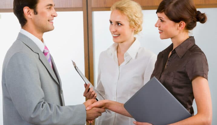 Business professionals shaking hands during a commercial agreement meeting
