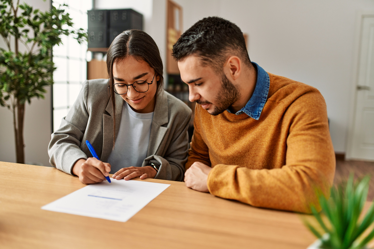 Couple signing a cohabitation agreement with legal guidance in Edmonton